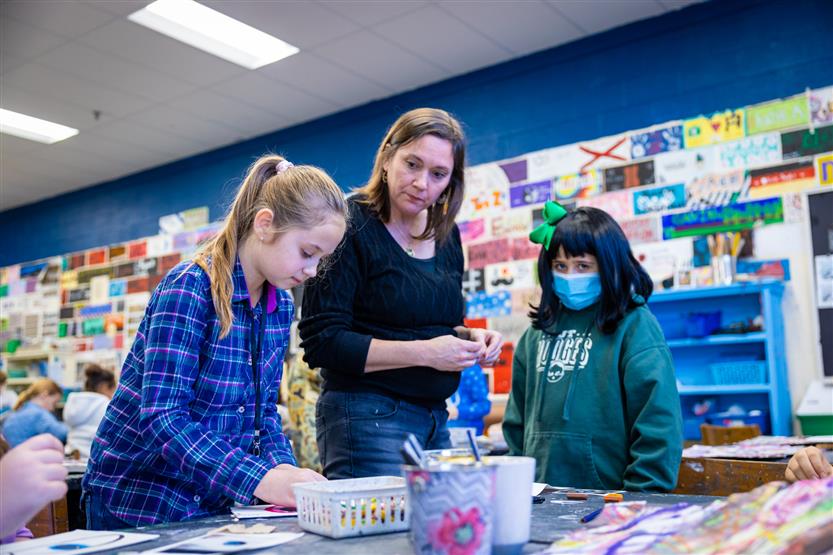 Students in an art class using oil pastels